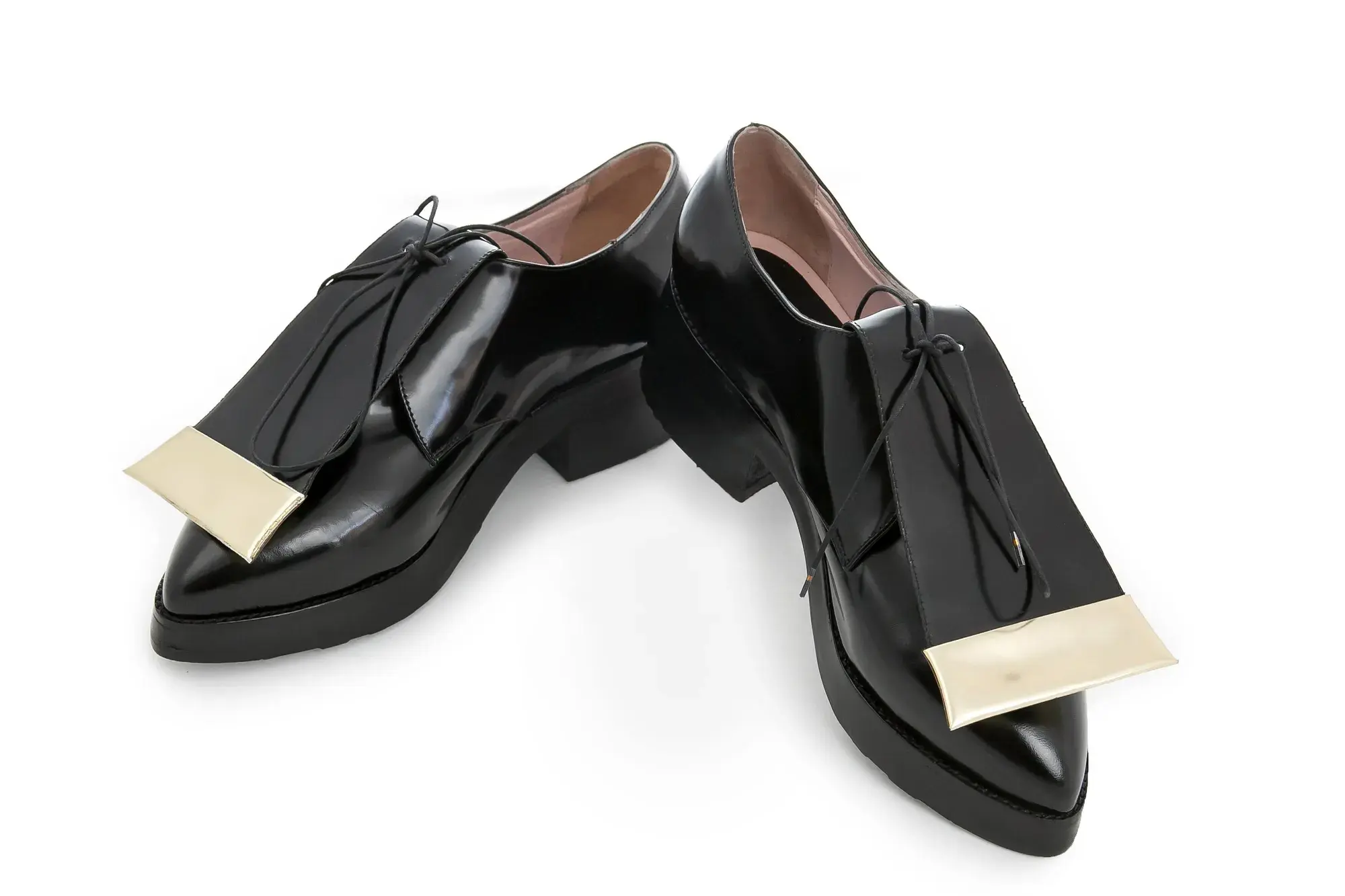 Black Patent Derbies, one resting across the other
