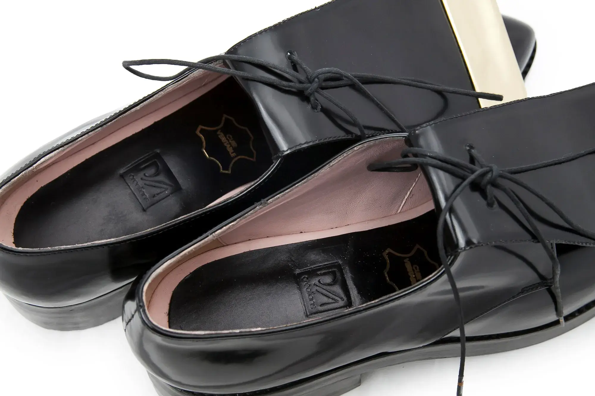 Inside the black patent derbies, showing the insoles