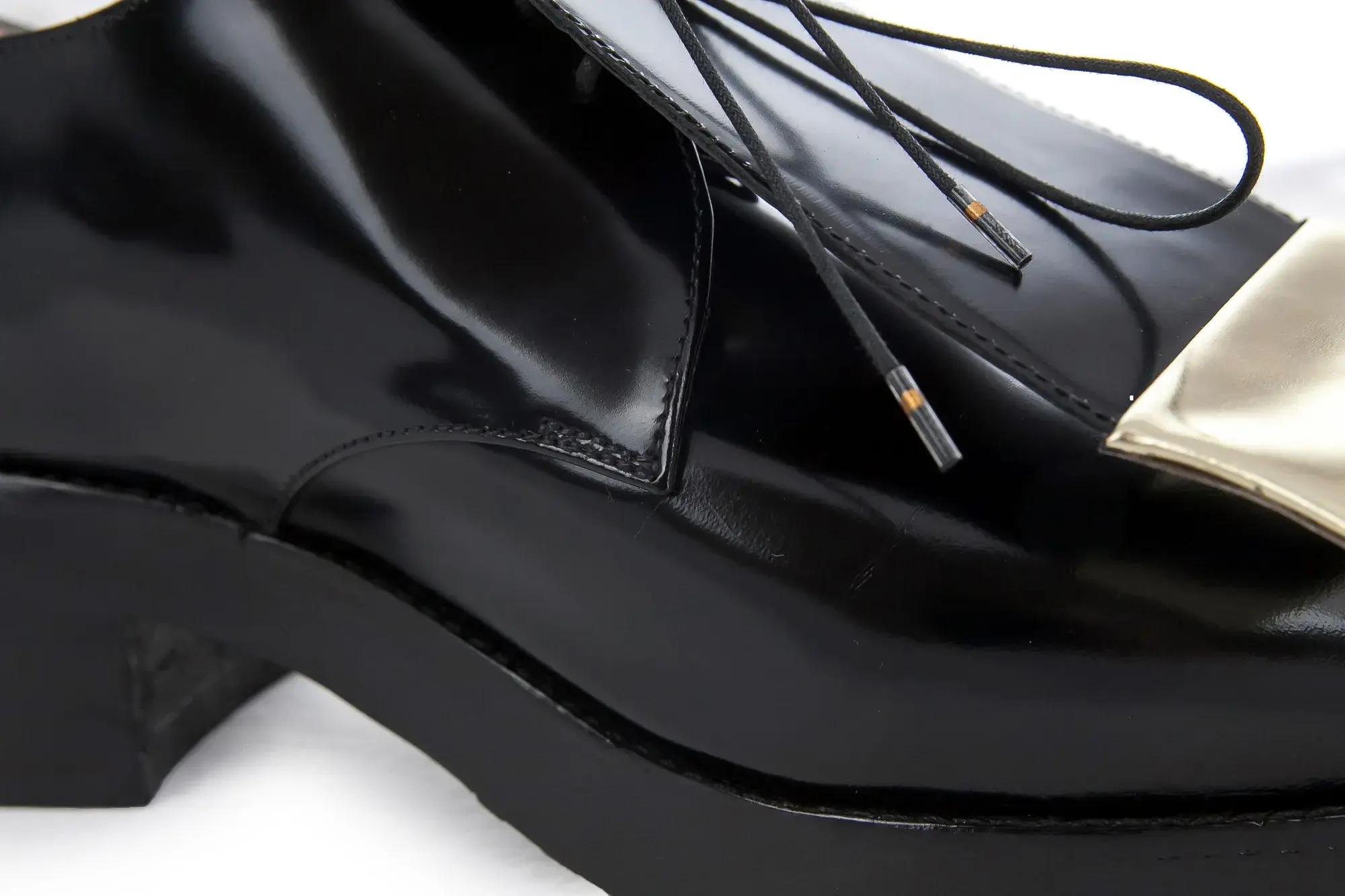 Heel detail of a black patent derby