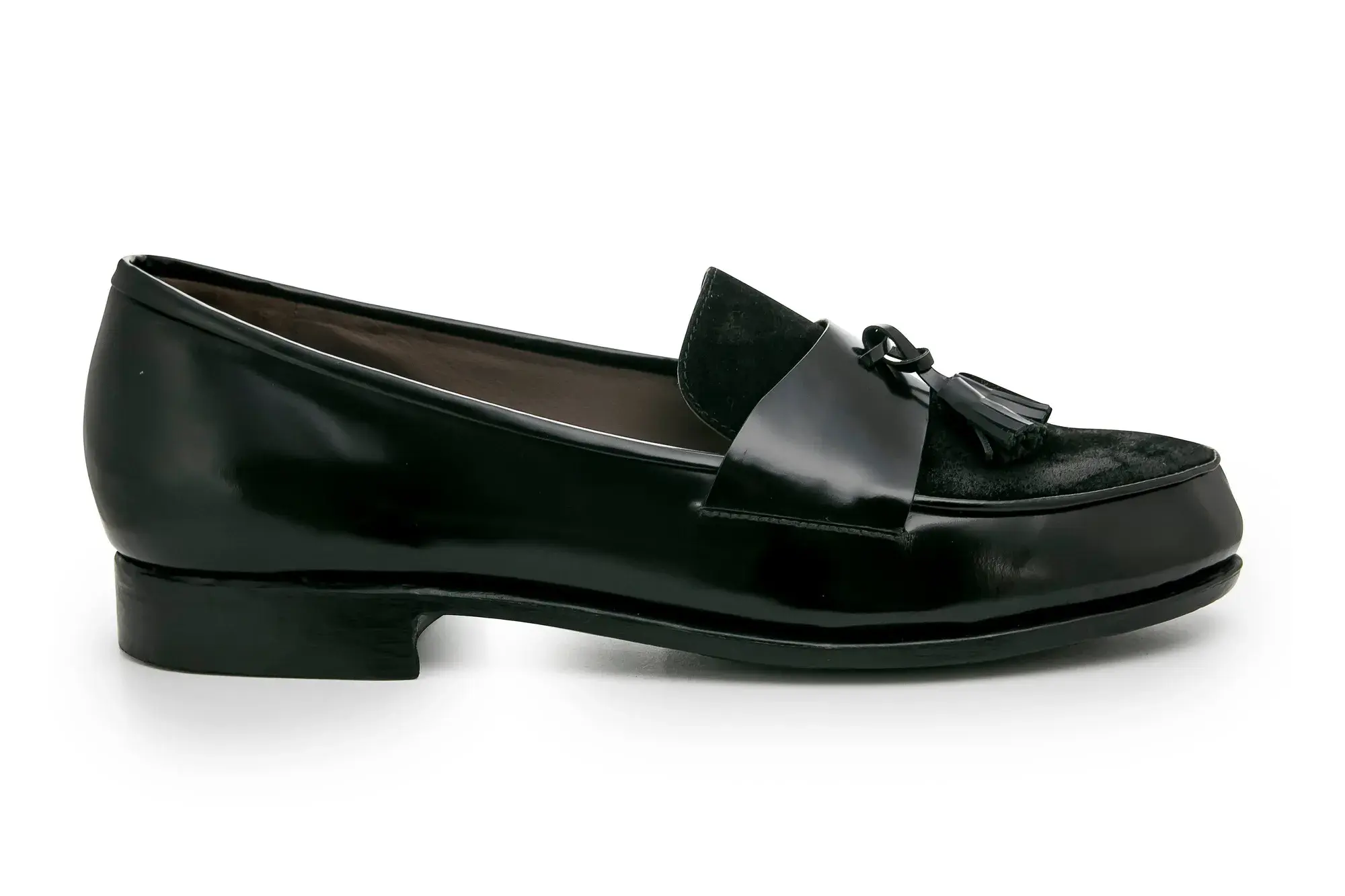A black tassel loafer seen from the side