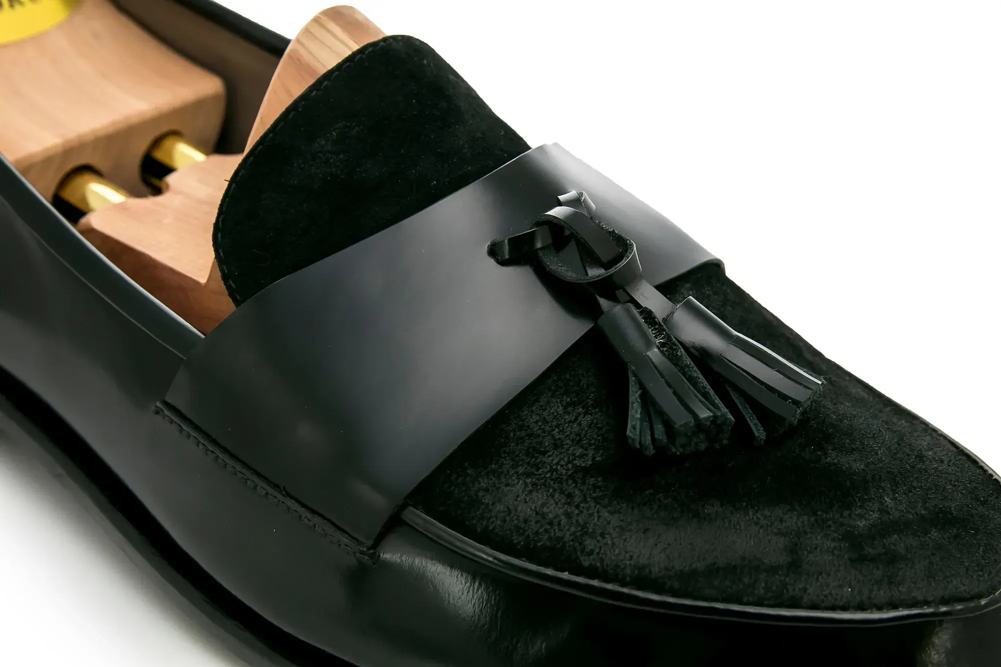 Vamp detail of a black tassel loafer