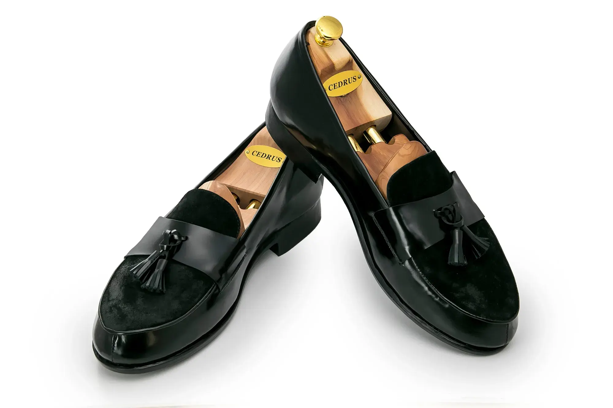 Black Tassel Loafers, one resting across the other