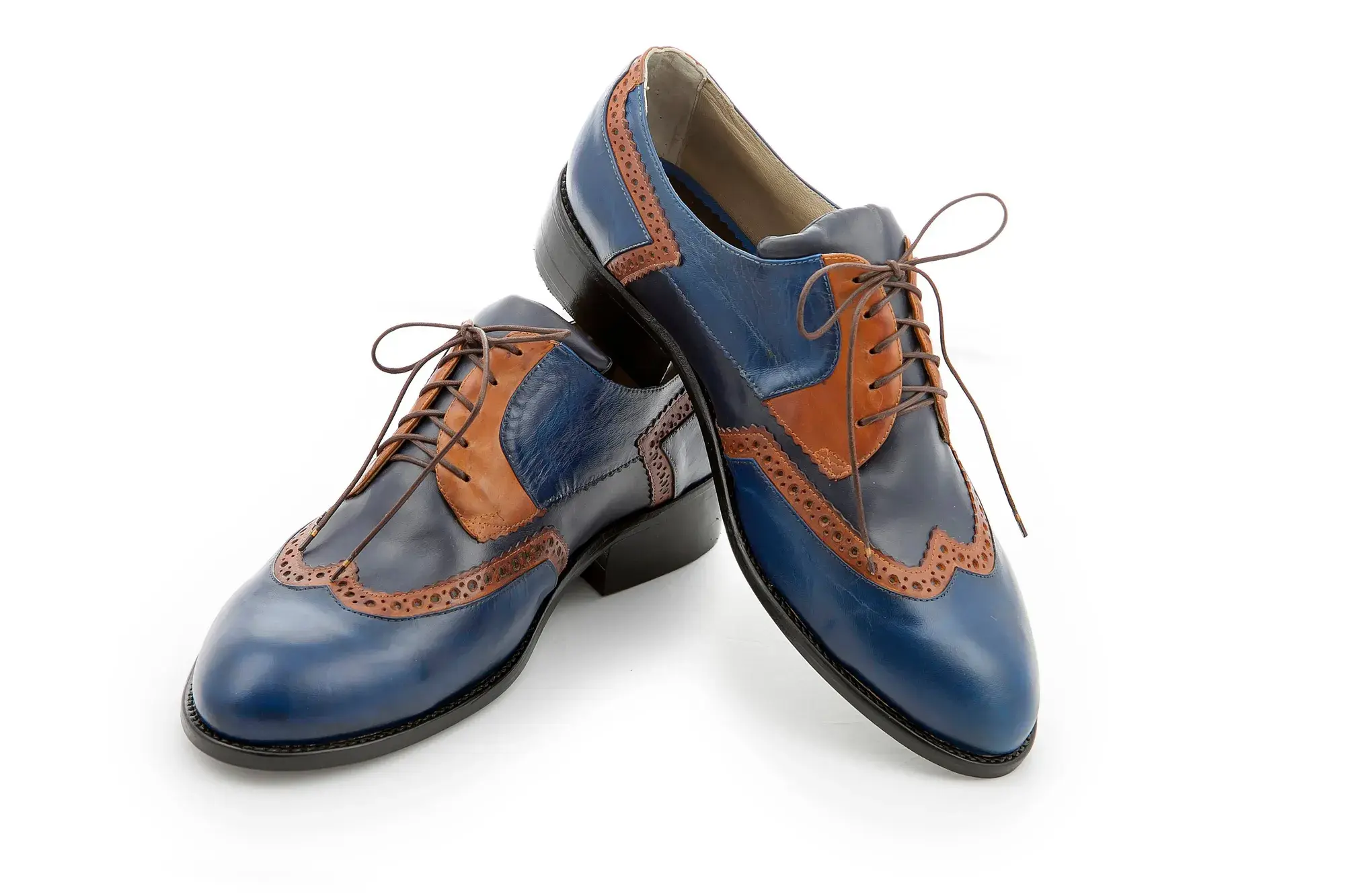 Blue and Tan Brogues, one resting across the other
