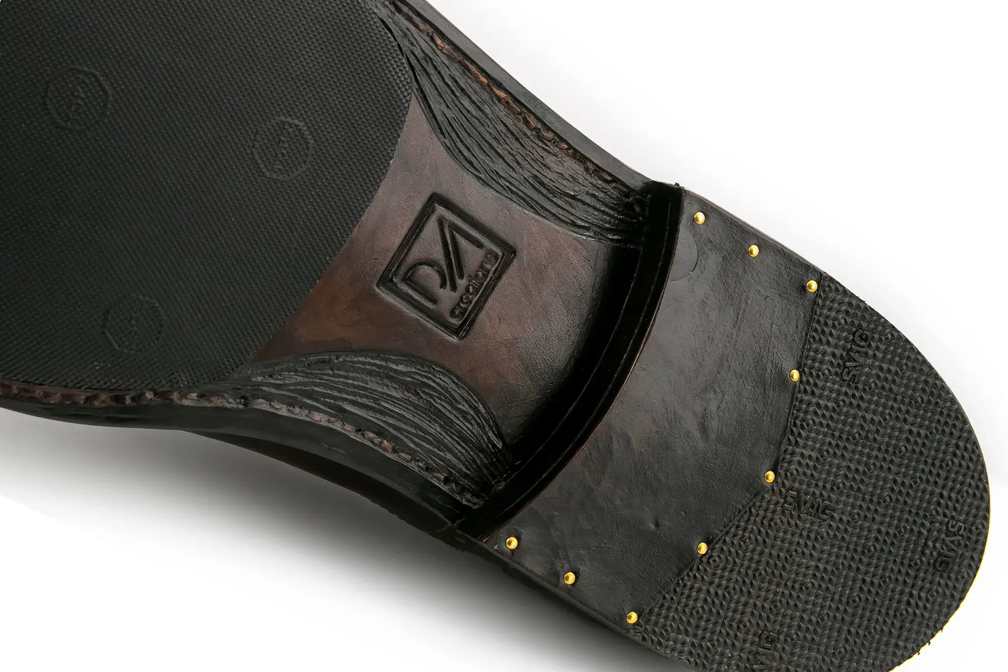The sole and heel of a brown and black brogue, close up