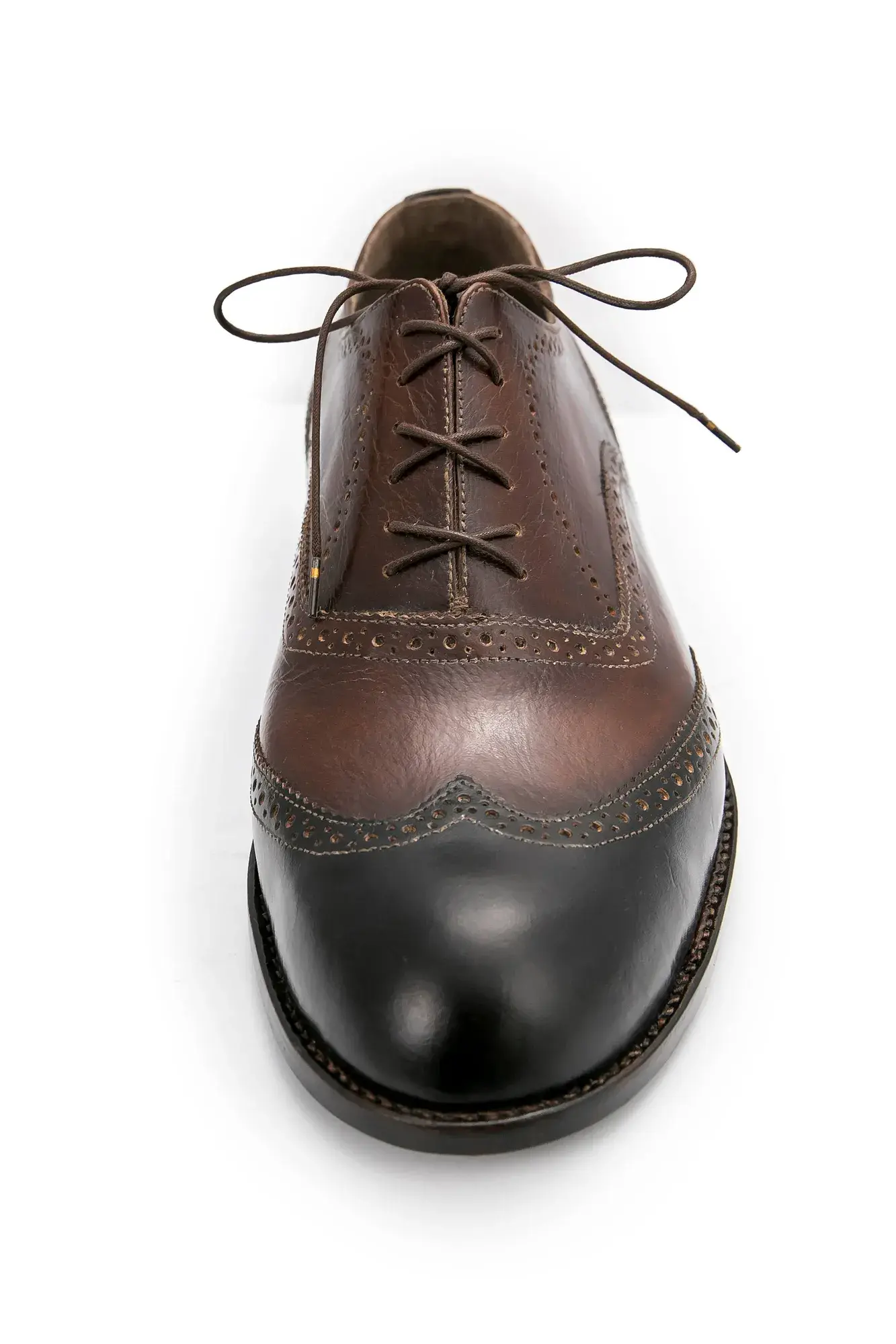 A brown and black brogue seen head-on from the toe