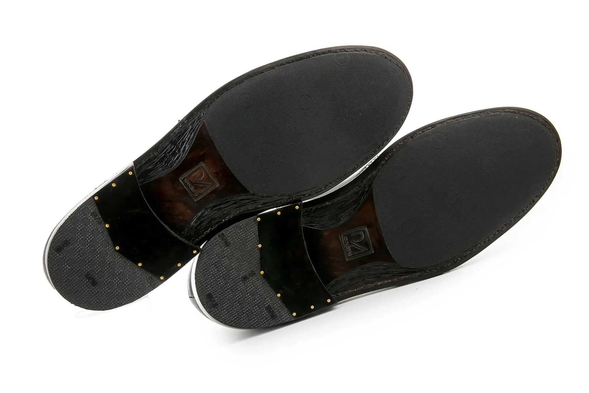 The soles of the brown and black brogues