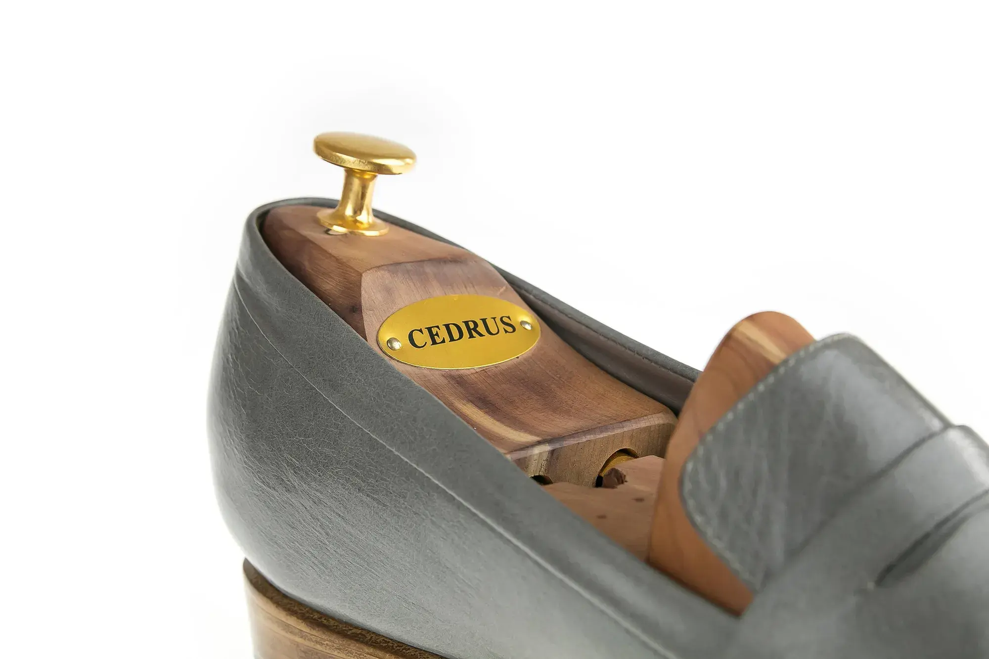 Side detail of a grey penny loafer