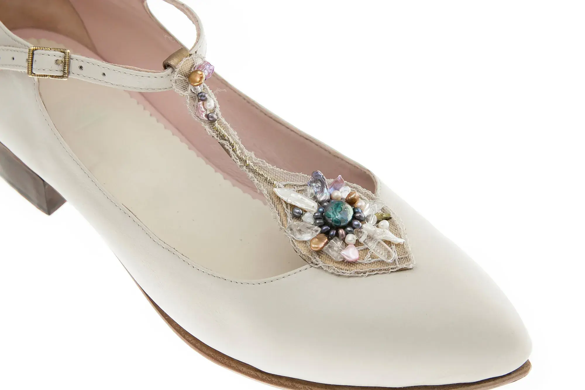 An ivory jewelled T-bar seen from the side