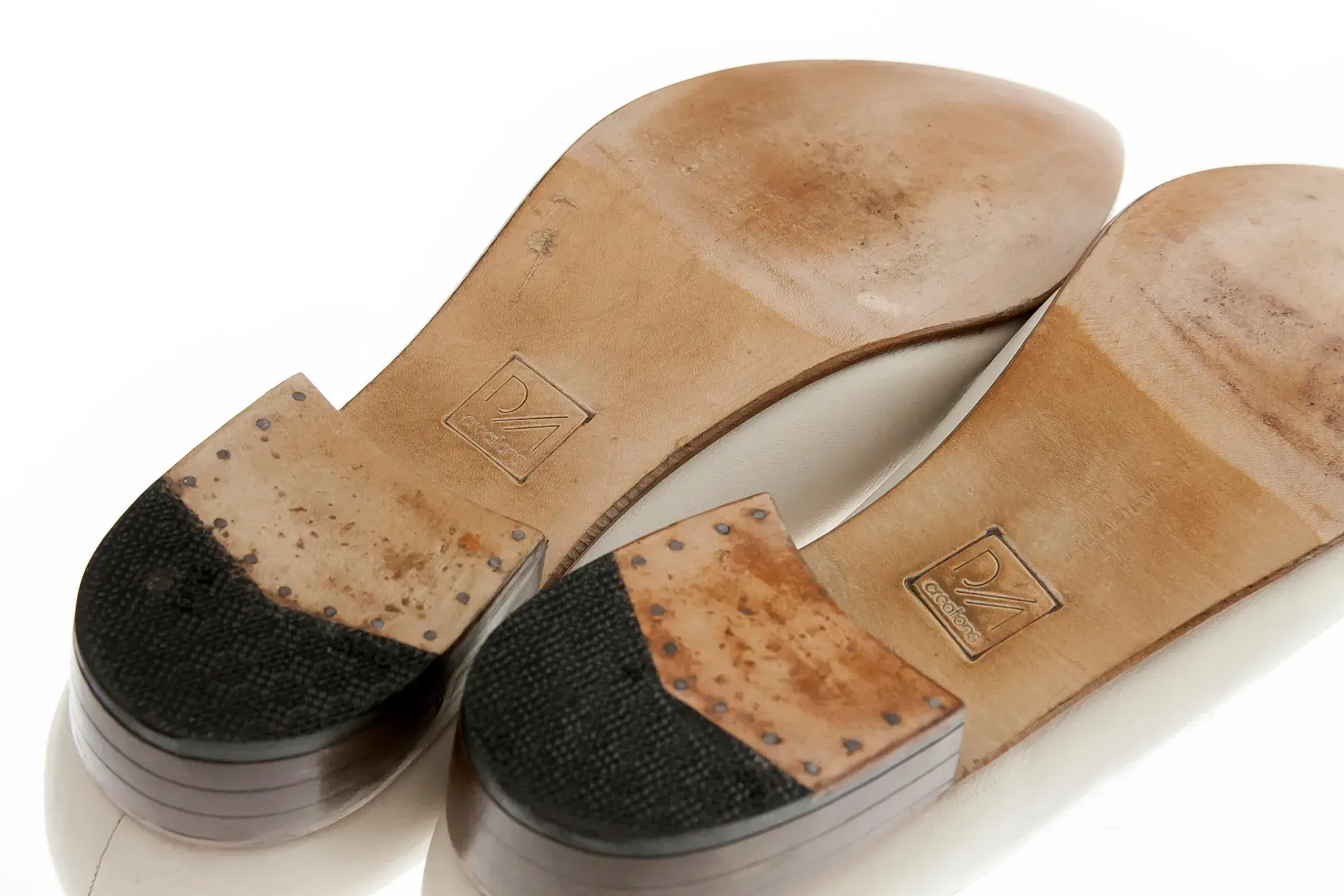 The soles of the ivory jewelled T-bars