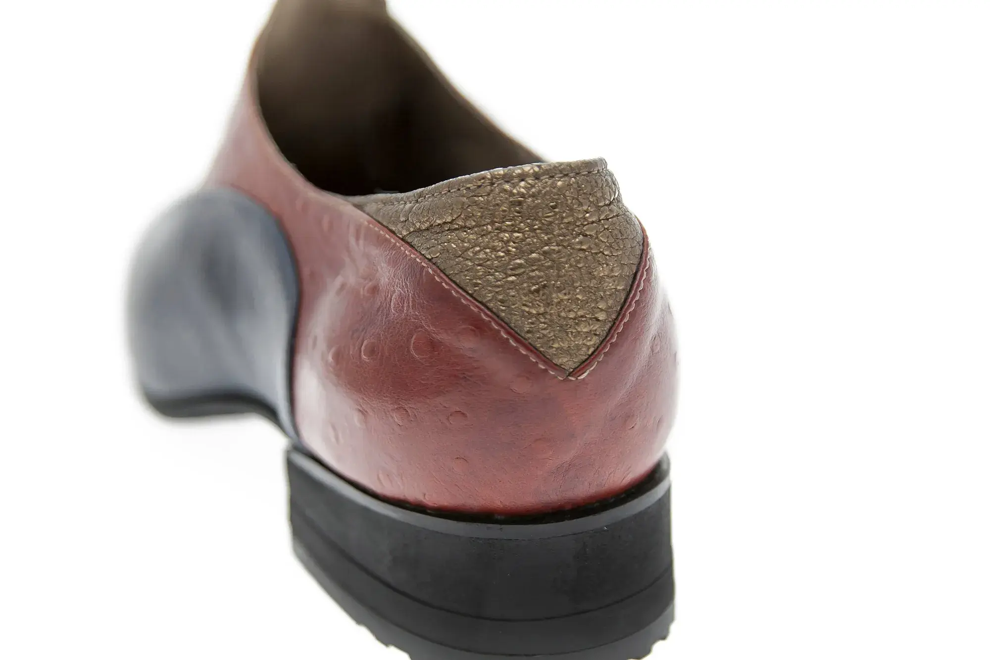 Heel detail of a navy and rust oxford