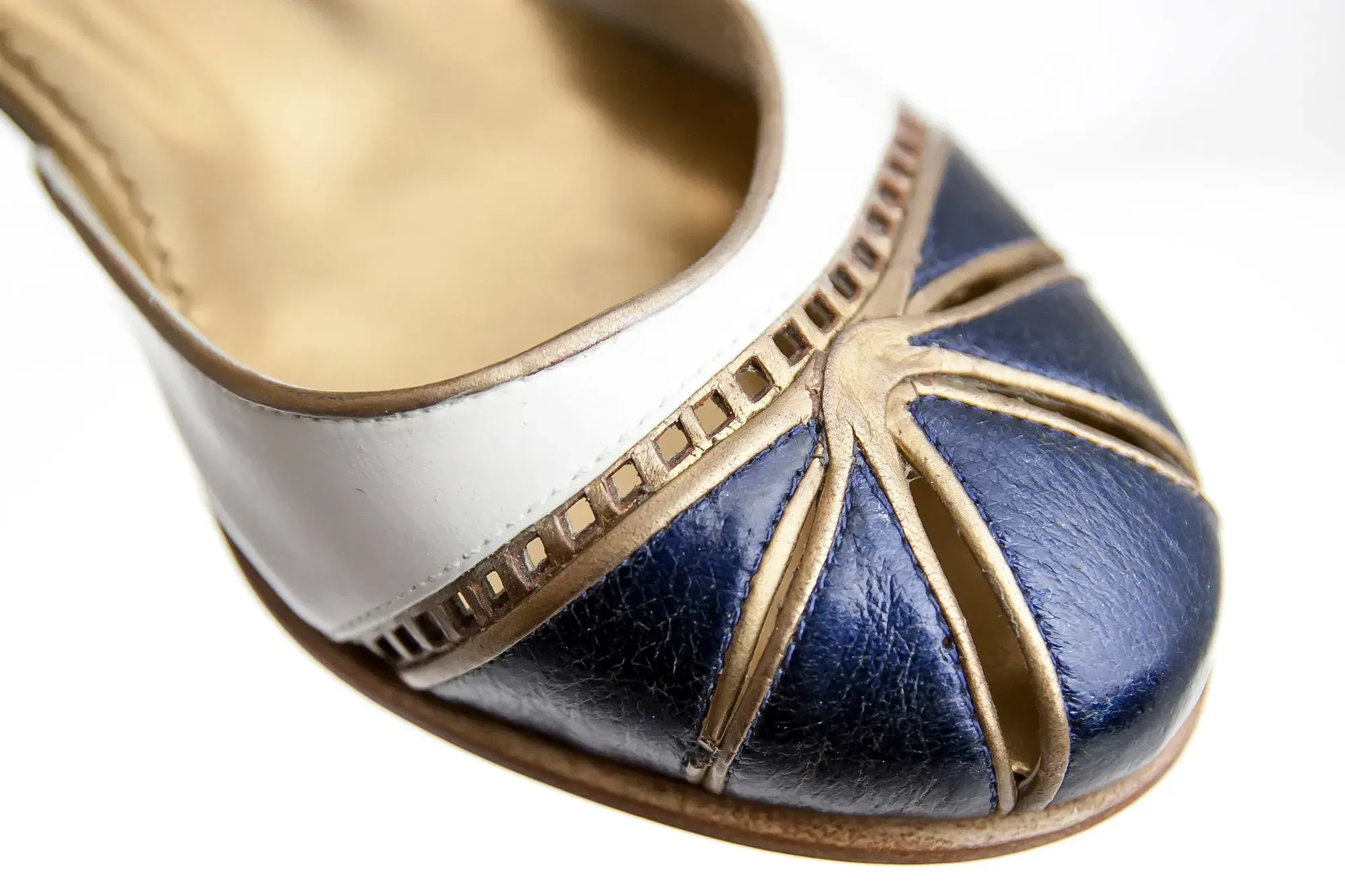 Toe detail of a navy, white and gold Mary Jane