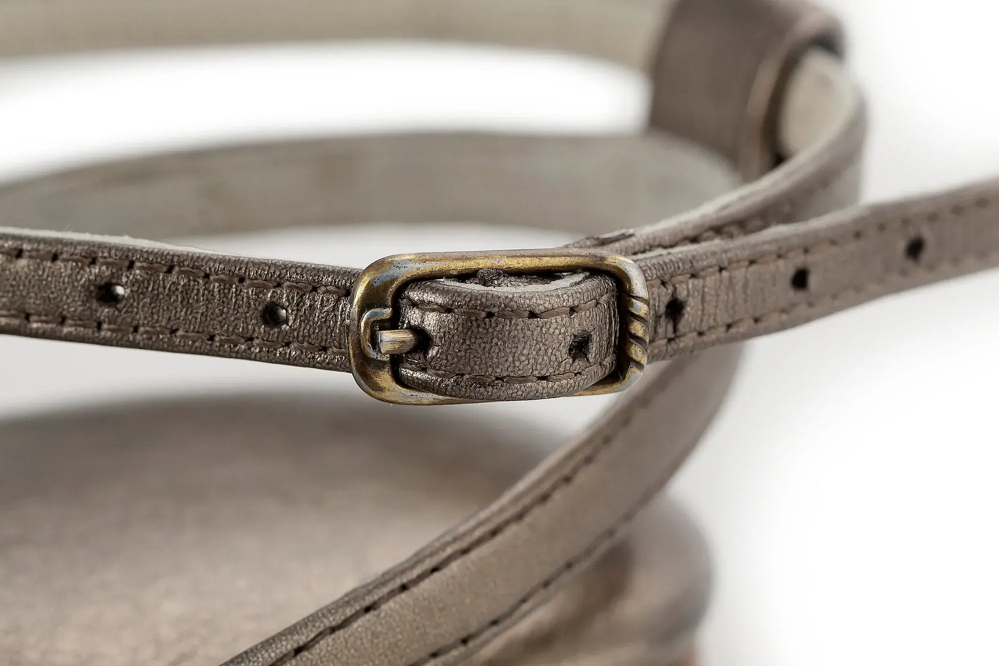 Buckle detail of a pewter sandal