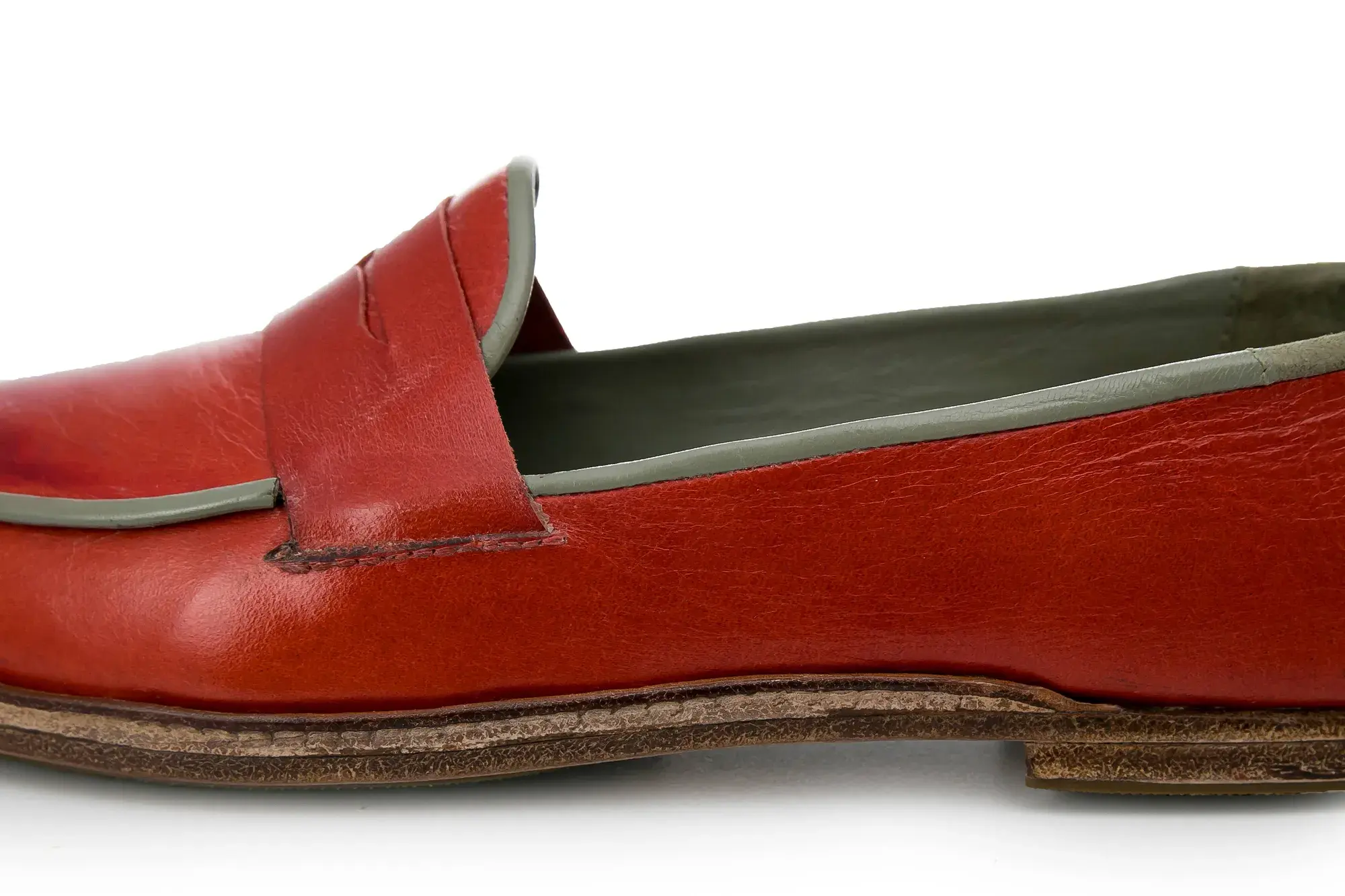 Side detail of a red penny loafer