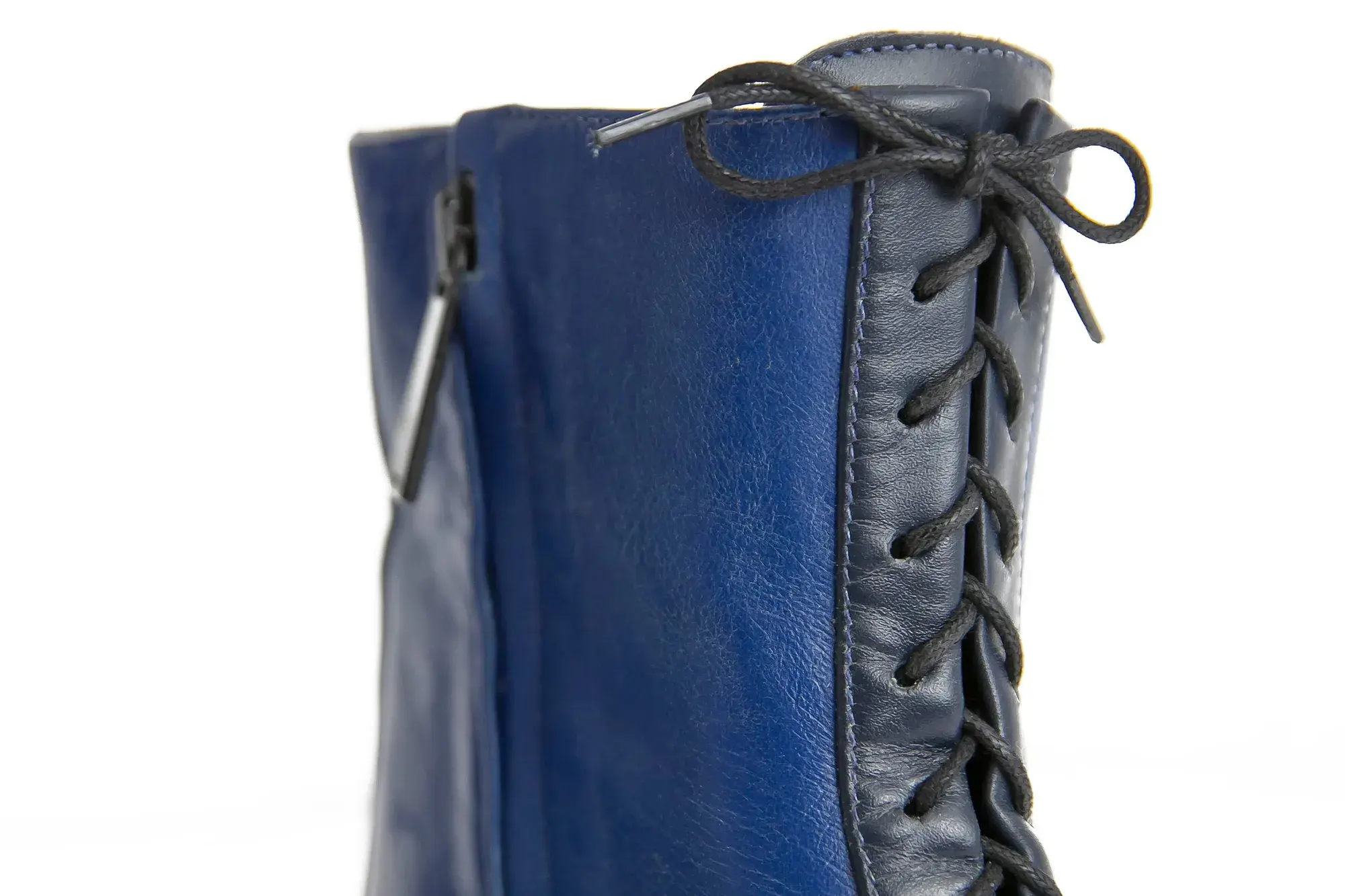 Zip detail of a royal blue and navy boot