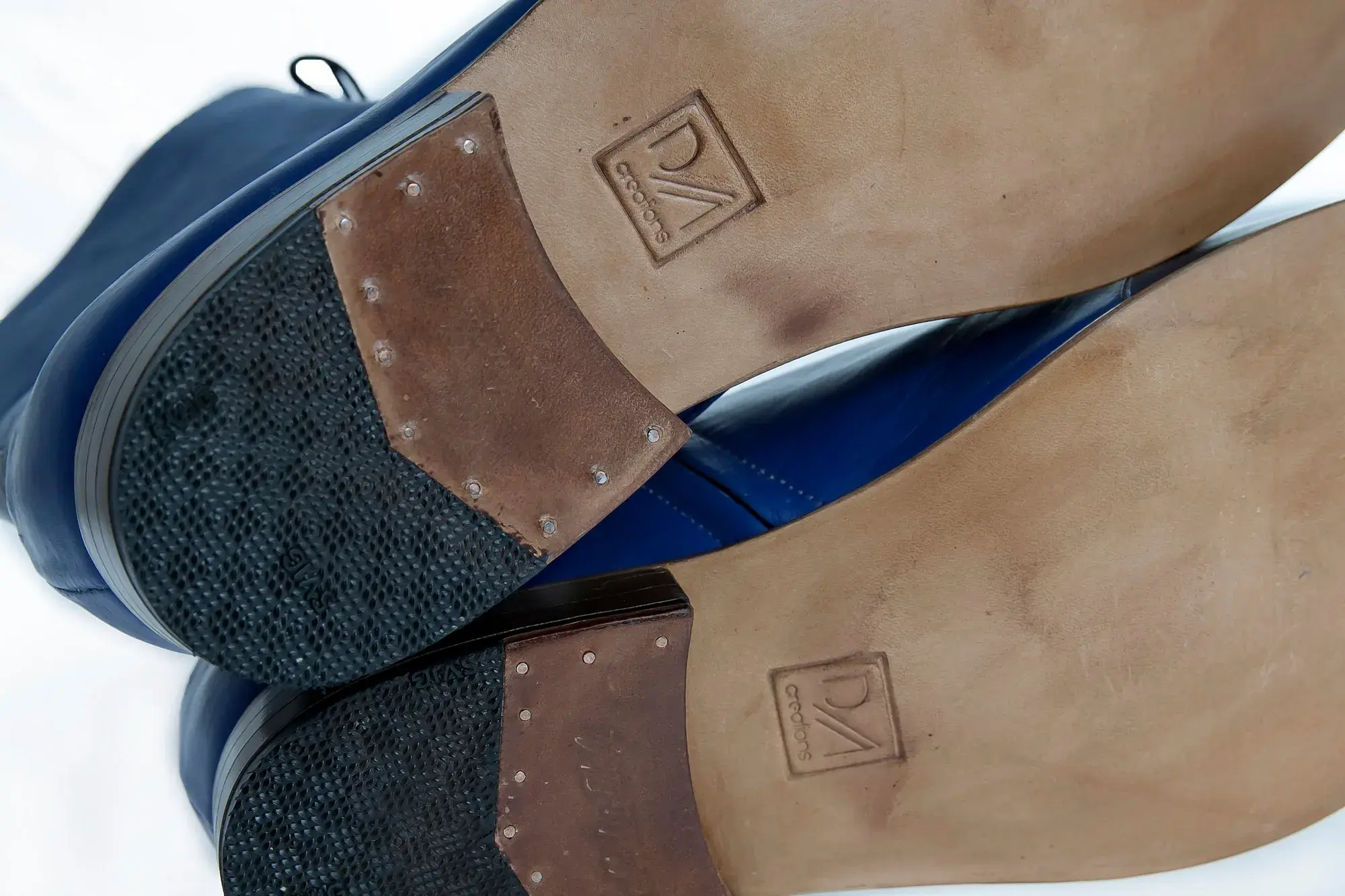 The soles of the royal blue and navy boots