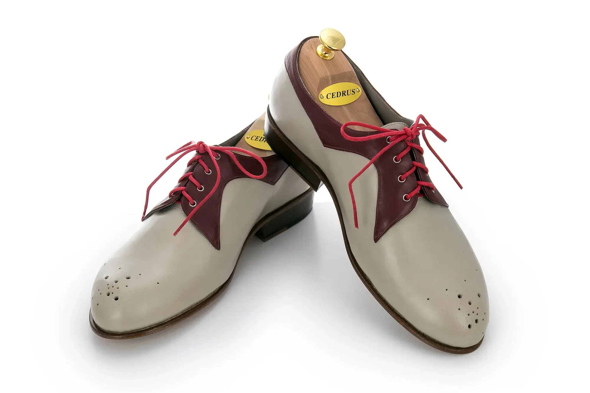 Stone and Burgundy Derbies, one resting across the other