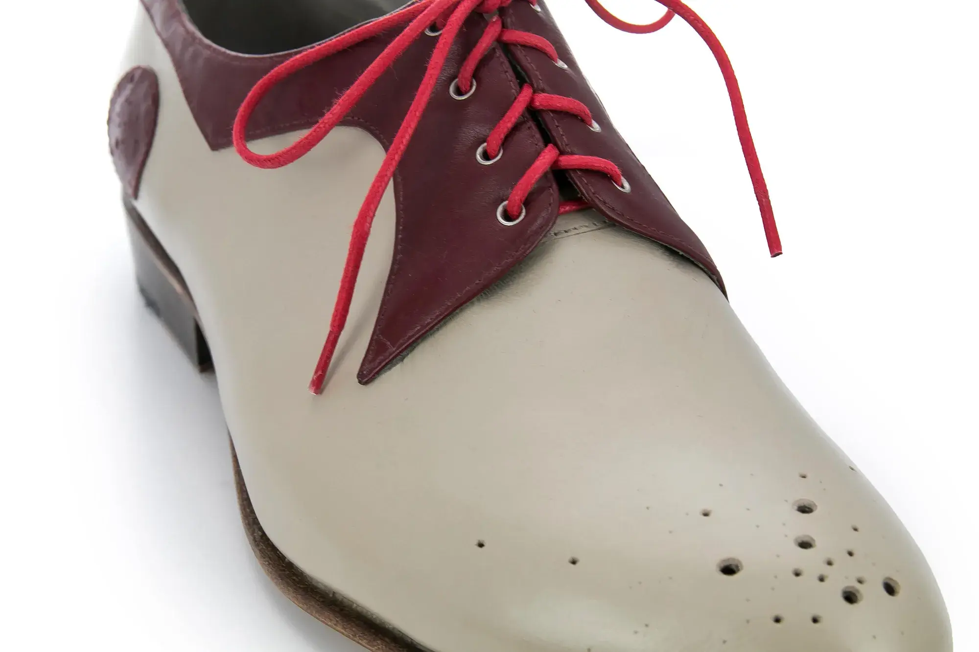 Toe detail of a stone and burgundy derby