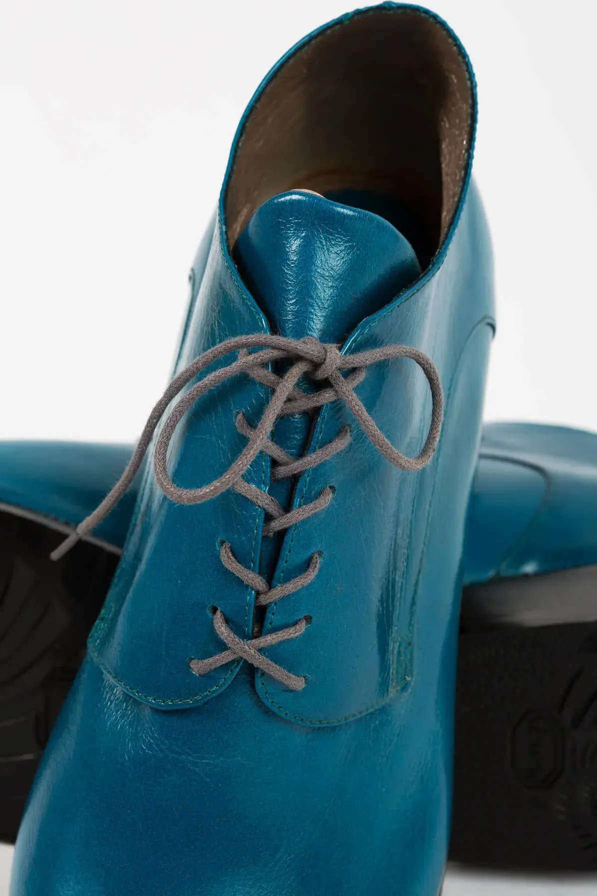 Lacing detail of a teal lace-up