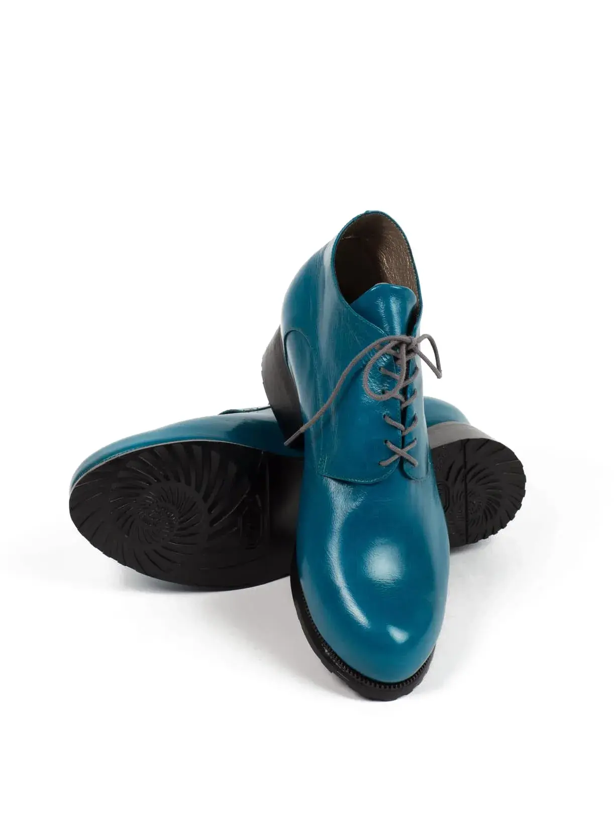 Teal Lace-ups, one resting across the other