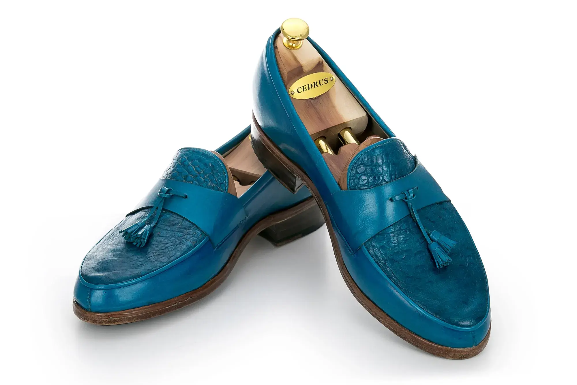 Turquoise Tassel Loafers, one resting across the other