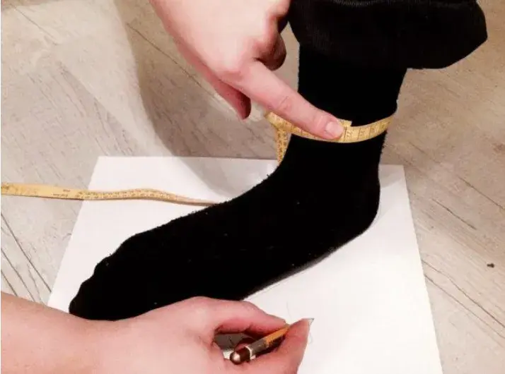 A tape measure around the ankle above the bone