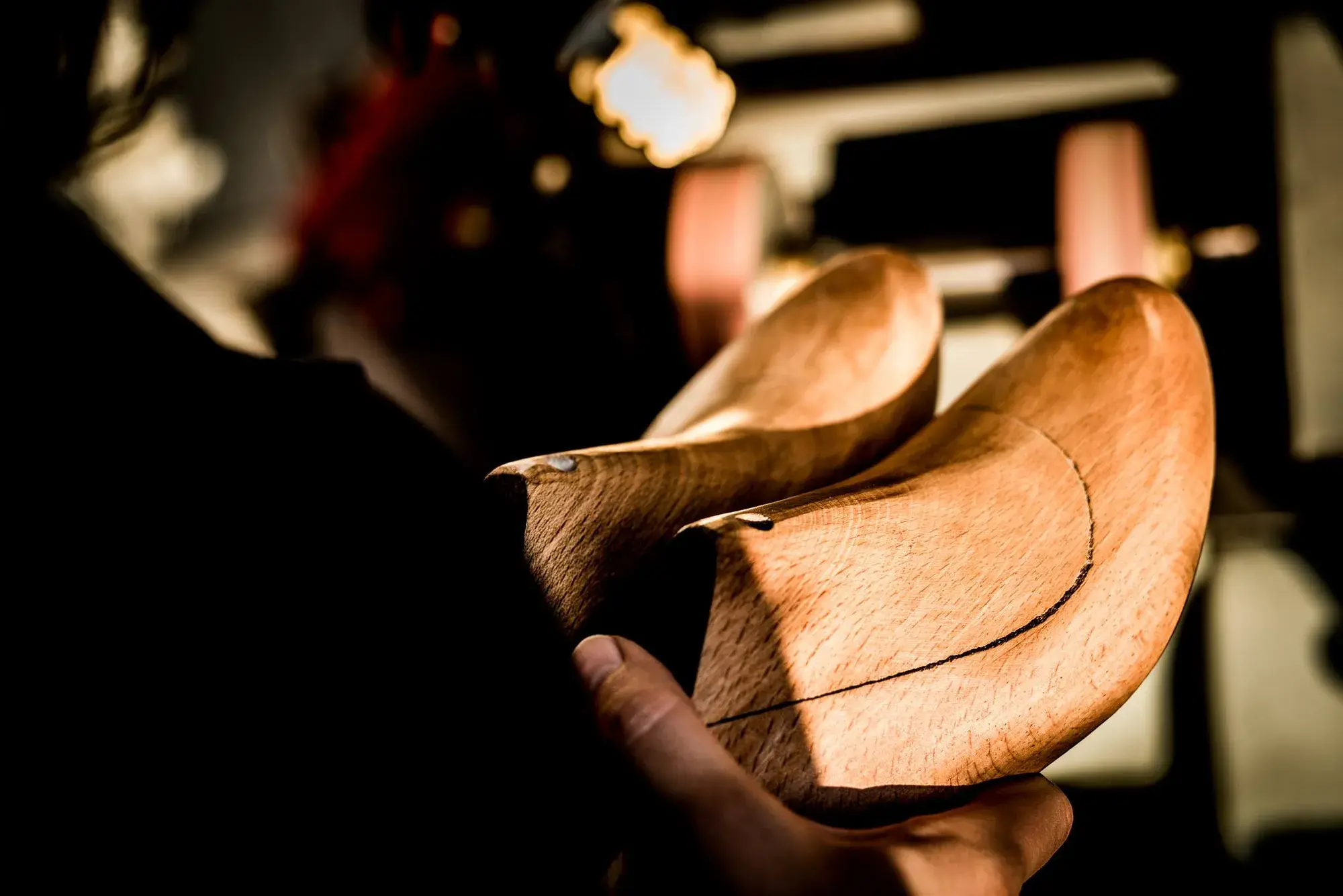A pair of wooden lasts with a pencil line drawn along them
