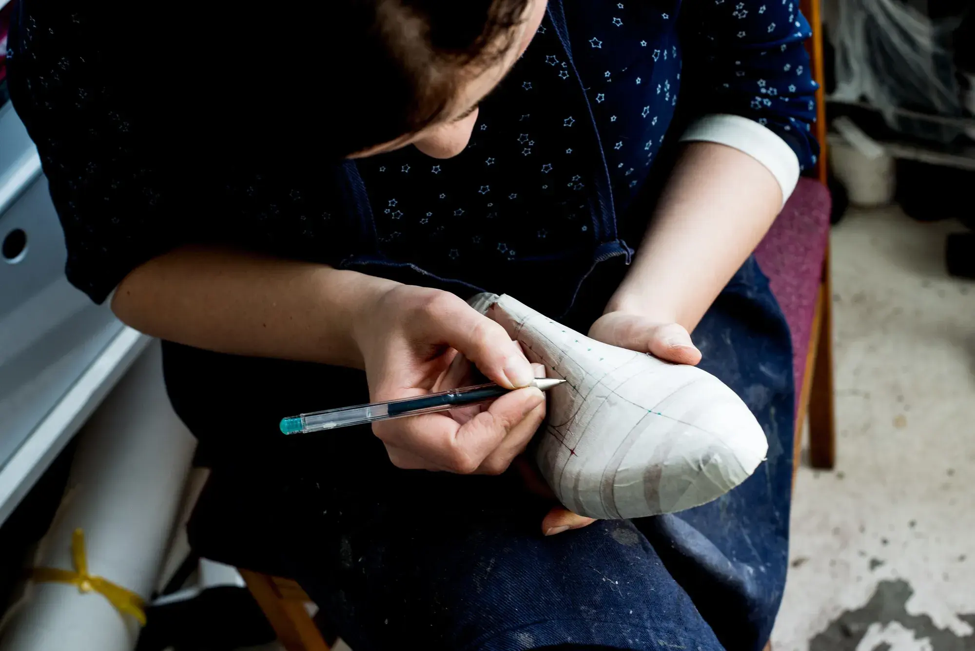 Pen lines being drawn along the side of the taped last