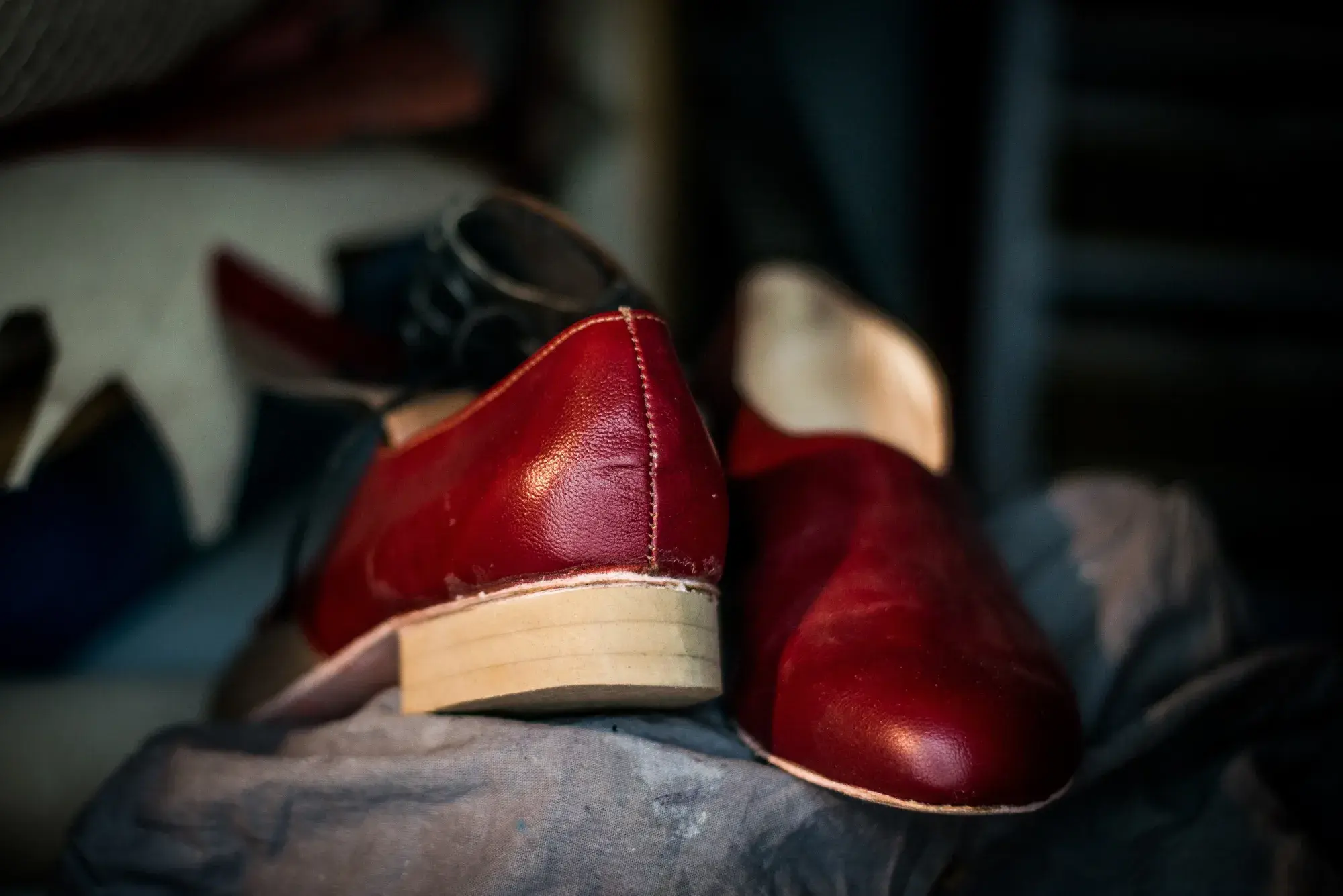 A pair of red trial shoes on a dark cloth
