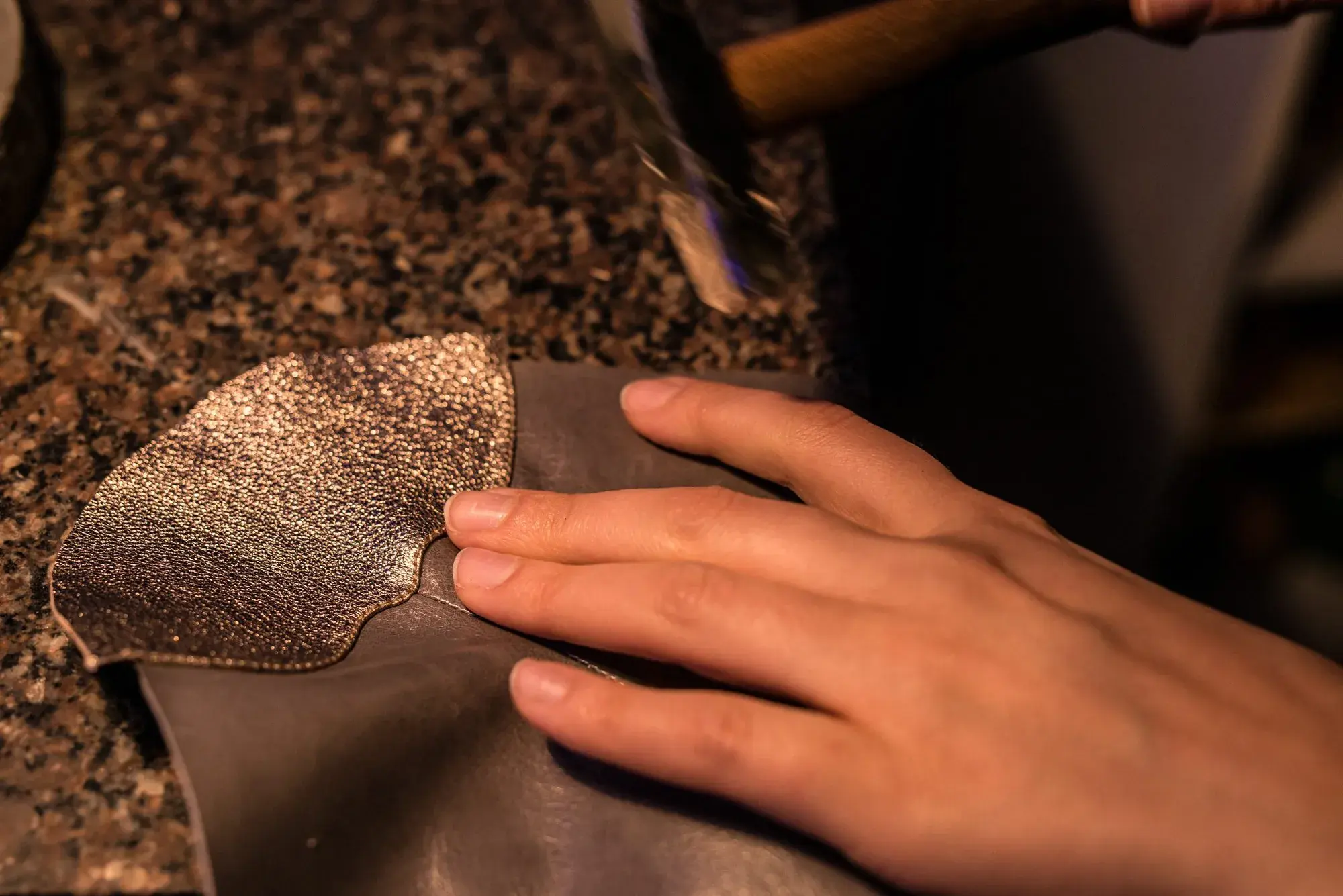 A leather seam being hammered flat