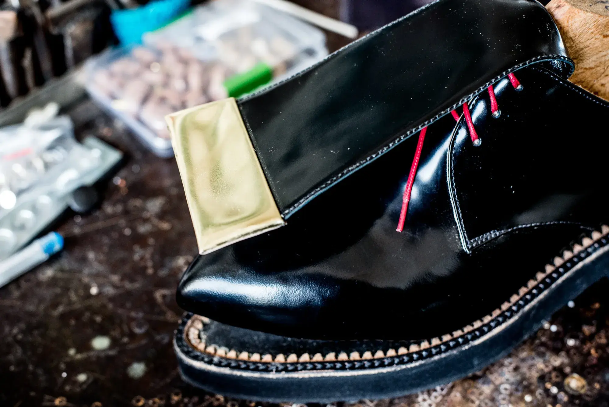 The welt of a black patent shoe, close up
