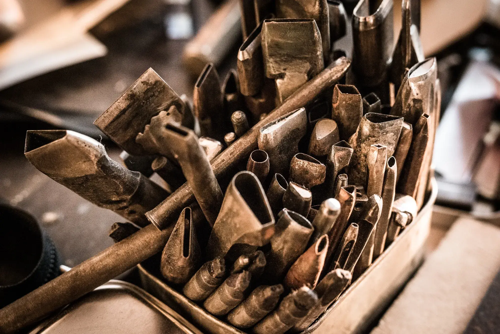 A crate of worn hand punches and tools
